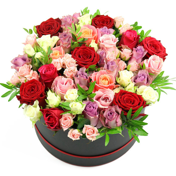 In this image, a lavish floral hatbox arrangement takes centre stage, isolated against a crisp white background that makes every colour and contour stand out clearly, as if viewed on the counter of a boutique florist off Golders Green Road. The container itself is an elegant black cylindrical hat box with a slim red trim encircling its base, giving it a tailored, high-end look, like a gift carefully chosen for a special moment. Rising from this stylish box is an opulent, dome-shaped mass of fresh roses, overflowing so generously that the blossoms spill out beyond the rim in a soft, cloud-like curve. The colour story is rich and nuanced: deep crimson and scarlet roses provide a passionate heart to the design, while romantic fuchsia and gentle blush pink blooms soften the overall impression. Warm coral and delicate peach roses weave between them, adding sunlit warmth, and creamy white or ivory roses punctuate the dome with flashes of brightness that catch the eye. Intermixed are sophisticated lavender and muted purple roses, bringing a cool, refined balance that feels very at home in the calm residential streets of Golders Green and nearby Hampstead Garden Suburb. The roses vary in size and stage, from tight, promising buds and small spray clusters to fully open, multi-petalled blooms that show off their complex spirals and velvety textures. Small sprigs of fresh greenery, perhaps ruscus or eucalyptus, are tucked thoughtfully among the petals, creating fine lines of green that set off the roses' colours and enhance the rounded silhouette. The lighting is soft and even, emphasising the freshness and natural sheen of the petals without harsh shadows. The overall effect is of a carefully composed, premium flower box, ideal for same-day delivery across NW11 for anniversaries, birthdays, Valentine's Day, or any occasion where a grand, heartfelt gesture is needed.