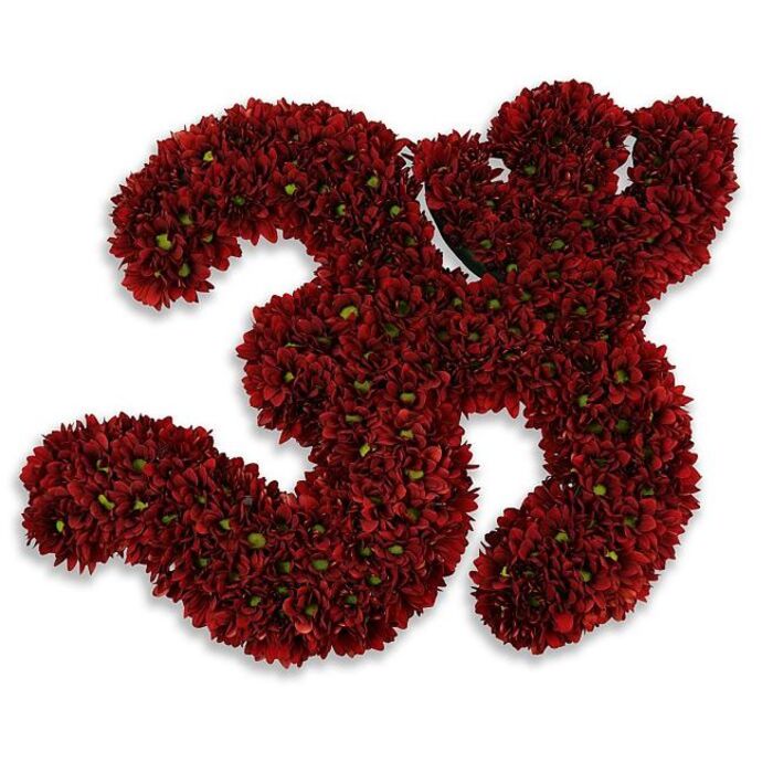 A bold, meticulously assembled floral numeral forming the number 33, presented on a stark white field so every petal and contour reads with clarity. The two threes are composed of countless small, button-style chrysanthemums in a saturated burgundy or crimson, packed so closely that the overall surface appears plush and velvety, almost like a textile swatch in deep wine tones. Tiny green eyes or leaf tips peek intermittently from within the flower heads, introducing a fresh, organic counterpoint that enlivens the dense red carpet. The arrangement sits slightly raised from the background, its soft gray shadow suggesting lift and three-dimensional weight; this shadowing lends the piece dignity and a gentle sense of celebration or reverence, depending on context. As a florist's construction it demonstrates tight wiring and careful massing techniques that preserve clean numeral shapes while maintaining natural flower movement at the edges. The scent would be understated, green and slightly earthy, the hallmark of newly cut chrysanthemums. Purposefully versatile, this floral 33 can mark a 33rd birthday, a significant anniversary, a cherished jersey number, or a solemn memorial commemoration. Locally, this kind of work is well-suited to hand-deliveries across Golders Green, from intimate family gatherings to community halls, and to be used as a striking image in seasonal window displays or event signage where clarity and craftsmanship matter most.