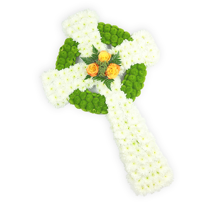 A striking funeral tribute photographed from a slightly elevated viewpoint on a clean white background, this floral Celtic cross is composed with meticulous craftsmanship. The main mass is made of tightly packed white spray chrysanthemums whose small, layered petals create a soft yet defined surface across the arms and the extended lower stem, giving the piece a plush, sheltered feeling. Interspersed within that white field are sections of bright lime-apple green button chrysanthemums; these compact, spherical blooms are placed to delineate the circular ring at the centre of the cross and to alternate through the horizontal arms, producing a refined Celtic-knot suggestion and a pleasing rhythm of colour. Anchoring the design at the very centre, three orange-yellow roses-rich with warm, golden undertones-are gathered in a neat cluster; their fuller blooms offer a focal warmth that contrasts beautifully with the cooler white and green. Dark green foliage, possibly fern fronds, frames and supports that rosy core, accentuating depth and lending a natural, respectful finish. The soft studio lighting defines petal texture and three-dimensional shape, while the arrangement's colourway-white, green, and orange-subtly evokes Irish heritage and could be chosen to commemorate cultural ties at a memorial service in the Golders Green area, perhaps for families gathering near Golders Hill Park or Golders Green Road. The overall impression is one of solemn dignity and tender remembrance; the work reads as a considered sympathy piece intended to honour memory with understated beauty.