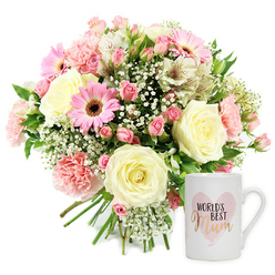 Set against a bright white background, this thoughtfully arranged gift set feels like a moment of quiet celebration ready to be delivered to a doorstep in Golders Green. On the left, a lush, rounded bouquet is gathered in a loose but perfectly balanced shape, the stems visible at the base to show it has been hand-tied by an experienced florist. Creamy roses, fully open yet still firm at the edges, are nestled at the centre, their petals layered in soft spirals. Around them, blush pink carnations create ruffled cushions of colour, while vivid pink gerbera daisies with contrasting dark centres lift the whole arrangement with their sunny faces. Darker pink spray roses, some in tight bud and others just unfurling, add depth and a sense of movement, as if the bouquet will change and soften over the days ahead. Slender white alstroemeria, each floret traced with fine reddish-brown speckles, introduce a graceful, elongated line. In between, tiny tufts of white baby's breath float like little clouds, softening the transitions between blooms and enhancing the gentle, romantic mood. Fresh green foliage peeks through throughout, offering a cool, leafy contrast to the warm, pastel tones. To the right of the flowers, a smooth white ceramic mug stands upright, decorated with a light pink, watercolour-style heart. Inside the heart, the words "WORLD'S BEST Mum" are displayed, with "Mum" picked out in a shining gold script that catches the eye without overpowering the soft design. The image evokes a sense of gratitude and affection, perfect for Mother's Day, a birthday, or a simple thank-you for a mum in the NW11 community.