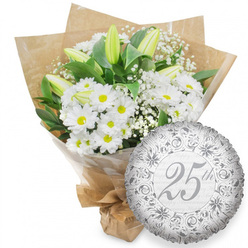 A graceful 25th anniversary gift set is displayed against a spotless white backdrop, as if laid out in a quiet Golders Green studio before being sent off for same-day delivery nearby. Dominating the left side of the image is a lush bouquet of white chrysanthemum daisies, each flower presenting a bright yellow centre ringed by tidy white petals that feel fresh and lively. Punctuating this sea of white are tall, tapered lily buds, long and elegantly closed, their creamy petals edged with a hint of green that suggests purity and new chapters still to unfold. Wispy sprays of baby's breath drift in and around the main blooms, adding a soft, almost mist-like texture that lightens the overall composition. Beneath and behind the flowers, deep green leaves fan out, providing a rich, natural frame that makes every white petal appear even crisper. The bouquet is secure in a layer of transparent cellophane and then wrapped in folded brown kraft paper with gentle creases and folds, giving the design a warm, hand-crafted feel, as if prepared by an experienced local florist who knows the tastes of couples celebrating milestones near Hampstead Garden Suburb. Tucked to the lower right, slightly overlapping the stems, sits a round silver foil balloon. Its mirrored surface is patterned with elegant baroque-style scrollwork and subtle floral detailing in deeper tones of silver-grey. At its centre, a stylish script reads "25th," surrounded by a faint, repeated "Happy Anniversary" motif that circles the balloon like a soft echo. The combination of pristine whites, gleaming silver, and natural paper tones conveys a sense of long-lasting love, calm celebration, and understated luxury.