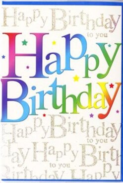 The image shows a festive birthday card, photographed so that the entire front design fills the frame, much like a shop display catching your eye as you stroll through Golders Green toward the station. Dominating the centre is the phrase "Happy Birthday," written in large, playful block letters that arc gently across the card, as if buoyed up by invisible balloons. Each letter is drenched in a smooth gradient of colour, sliding from deep ruby and magenta through marmalade orange, golden yellow, vibrant lime and teal into royal blue and purple, with no harsh lines between them. The effect feels painterly and soft, like watercolours blending across thick paper, or a carefully graded ribbon twining through a celebratory bouquet. The letters have a glossy, almost enamelled finish that reflects the light, giving a sense of movement as if the colours are alive. Behind this main message lies a layer of refined detail: a pale background washed in creamy white, covered with repeated lines of "Happy Birthday to you" scrolled in elegant, looping gold script. The calligraphy-style writing is smaller and more delicate, running horizontally behind the main words like a gentle chorus of birthday wishes murmured in the background. The metallic gold ink catches the light subtly, similar to the way late-afternoon sun glints off the synagogue domes and townhouse windows around Golders Green. A scattering of tiny star-like flecks and sparkles sits among the letters, suggesting confetti or sugar sprinkles, and adding a sense of light-hearted fun. The design manages to feel both modern and classic, making it a versatile greeting for a milestone celebration or a simple, joyful birthday, whether you're gathering in a local café on Finchley Road or celebrating at home.