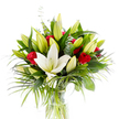 The image shows a tall, carefully balanced bouquet set in a simple cylindrical clear glass vase, photographed against a bright white studio background so every colour and texture reads with clarity. Dominating the composition is a single, fully open creamy white oriental lily placed slightly forward at the centre; its smooth petals curl softly outward to reveal pale yellow stamens and a pale green pistil that catch the light like a quiet focal point. Around that central bloom a chorus of tightly closed and partially unfurled lily buds in pale lime green and soft yellow lend a sense of growth and gentle movement, as if several more flowers will open in the coming days. Scattered through the mass of blooms are several velvety red rosebuds and small roses, their petals largely furled to offer concentrated, passionate blots of colour against the lily's calm purity. The flowers are nested in abundant green foliage: broad, dark forest-green leaves provide a structured backdrop, while longer, feathery palm-like fronds in a brighter emerald cascade outward, adding energy and a tropical silhouette. Silvery-green eucalyptus stems with their rounded leaves are woven through the arrangement, offering cool contrast and a delicate texture. Through the transparent vase the pale green stems are visible submerged in fresh, clear water, reinforcing a sense of freshness and care. The overall mood is one of refined celebration and quiet romance - a bouquet that reads as pure and sincere, equally suited to an anniversary, a heartfelt congratulations, or as an elegant centrepiece for a small Golders Green gathering.