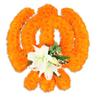 A meticulously crafted floral Khanda occupies the centre of a crisp white field, its form built entirely from hundreds of bright orange marigold blooms that have been tightly clustered to read as the sacred Sikh emblem. The marigolds' compact, velvety heads create a warm, textured surface that catches a soft, even light and gives each curve and edge of the symbol a plush, three-dimensional presence. At the heart of the composition, where the crossed blades would meet, a small, elegant cluster of at least two fully open white lilies rises-their broad, gently curved petals revealing delicate green-and-yellow stamens-surrounded by several smaller white lily buds that promise further unfurling. Sprays of tiny white filler flowers, likely gypsophila, and glossy green foliage tuck beneath and around the lilies, their cool tones offering a calm counterpoint to the exuberant orange. A faint drop shadow beneath the piece suggests it is a freestanding memorial or ceremonial display, not a flat illustration, and the overall balance reads as reverent and celebratory at once. The visual language here is unmistakably ceremonial: the bright marigolds suggest festival energy used in Vaisakhi or Gurpurab decorations, while the white lilies signal purity and solemn respect, suitable for offerings placed in a Gurdwara or for a community tribute. As a local florist would note, the textures-the marigolds' dense fluff, the lilies' satiny smoothness, the fine, papery gypsophila-work together to make an emblem that is both tactile and symbolic, quietly echoing the spiritual themes of unity, protection, and devotion familiar to congregations in and around Golders Green.
