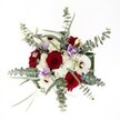 Beneath the gentle filter of North West London light, this stunning Golders Green bouquet captures both celebration and tranquility in a carefully balanced floral display. Lush, velvety red roses gather at the center, speaking softly of love and commitment, while radiant white gerbera daisies shine with pure optimism-each one punctuated by a dark, textured center that subtly commands attention. Between these, feathery white chrysanthemums add an ethereal softness, reminiscent of morning dew in Golders Hill Park, cushioning the arrangement with natural poise. Scattered lilac Eustoma blooms lend a quiet, modern twist-their pale purple tones a soothing relief to the vivid reds and whites. Around the blooms, arcs of silvery-green eucalyptus stretch, offering not just cool color and elegant structure, but a fresh, herbal fragrance like an open window on Finchley Road. Additional slender green leaves weave throughout, enriching the bouquet's depth and drawing all elements into harmony. Each flower, thoughtfully selected by Flowers Golders Green's expert hands, seems illuminated against a pure white background, making the arrangement perfect for everything from romantic dinners and birthday surprises to refined centerpieces at local gatherings. The bouquet's composition evokes a sense of serene celebration and gentle refinement, a signature of Golders Green's floristry at its finest.