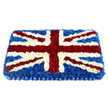In this photograph, a substantial Union Jack funeral arrangement is presented against a pure white backdrop, allowing the rich colours and textures of the flowers to take centre stage. The tribute is rectangular and confidently proportioned, its surface fully covered in densely packed small blooms-likely carnations and chrysanthemums-so that the flowers form a plush, slightly raised cushion. A generous expanse of dark, velvety blue flowers provides the base layer, representing the St Andrew's Cross and creating a sense of calm solidity. Across the middle, immaculate bands of crisp white blossoms form the upright and horizontal axes of the St George's Cross, their precision reflecting the steady craftsmanship of an expert florist at work, perhaps in a workshop just off Golders Green Road. Diagonal streaks of vivid red flowers, each neatly edged with thin lines of white, complete the St Patrick's Cross; together, these elements recreate the familiar Union Jack pattern with remarkable clarity and impact. The petals appear fresh and cool, as though the piece has just been misted and readied for same-day delivery to a chapel, church, or funeral home in Golders Green or nearby Hampstead. Soft, even lighting enhances the contours of the blooms, giving the flag a subtle three-dimensional quality. A pleated blue satin-effect ribbon runs along the bottom edge, forming a smart border that frames the tribute and adds a touch of ceremonial elegance. Overall, the floral flag conveys deep respect, patriotic remembrance, and heartfelt condolence-an especially meaningful choice for honouring a loved one who cherished their British identity.