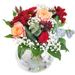This bouquet is a harmonious celebration of warm, inviting colors and textures, perfectly suited for a joyful moment in Golders Green-a vibrant area known for its friendly cafes and lush parks. The peach-apricot roses command attention with their soft, spiraling petals, infusing the arrangement with a gentle glow reminiscent of early sunsets over Golders Green Crescent. Deep crimson chrysanthemums and a singular velvety red rose add drama and rich depth, echoing the passion found in community celebrations. Wisps of white gypsophila create a delicate, cloudlike effect, contrasting beautifully with the bouquet's lush, glossy greens and adding a layer of playful elegance. Cool-toned eucalyptus leaves peek from the ensemble, their silver-blue hue introducing a subtle aromatic lift, as if fresh from a weekend stroll down North End Road. Dark plum succulent foliage brings a final note of depth and interest. Everything is cradled within a clear, round glass vase, layers of crossed stems and glistening water visible beneath-an emblem of freshness, artistry, and local pride. The arrangement is a testament to thoughtful craftsmanship, ideal for expressing gratitude, celebrating achievements, or simply bringing a touch of Golders Green's natural beauty into any home or office.