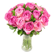A lush dome of roughly two dozen freshly cut pink roses sits in a clear, slightly curved glass vase, photographed against a clean white background. Each bloom opens in a classic spiral, the tightly furled centres carrying deeper fuchsia and magenta tones that melt outward into delicate blush pink and occasional hints of creamy white on the outermost petals. The petals catch bright, even light, revealing satiny textures, soft highlights and the gentle shadows where each layer folds back on itself. Sprigs of deep green foliage peek between the blooms, their smooth leaves offering a cool, textural contrast to the warmth of the roses. Through the transparent vase the trimmed stems show straight and crisp beneath the water line, suggesting recent cutting and careful conditioning. Close your eyes and you can almost sense the sweet, slightly fruity fragrance typical of garden roses, a scent that evokes early summer markets like the ones along Golders Green Road and mornings in nearby Golders Hill Park. The arrangement reads as both modern and timeless-perfect for an anniversary, Mother's Day, or to convey heartfelt sympathy-its rounded silhouette designed to sit as a focal point on a dining table or mantel. As a local florist who often prepares seasonal bouquets for residents around Finchley Road and Hampstead Garden Suburb, I'd describe this piece as quietly confident: the colour gradient in each bloom and the disciplined, dense clustering speak of technical skill and a devotion to classic romanticism. The overall impression is one of abundant tenderness, a floral gesture that communicates love, celebration, and thoughtful attention to detail.